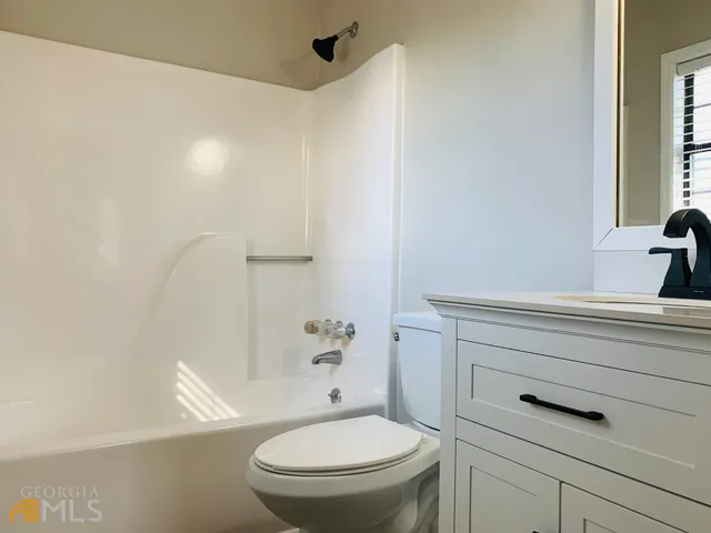 a bathroom with a toilet and a sink