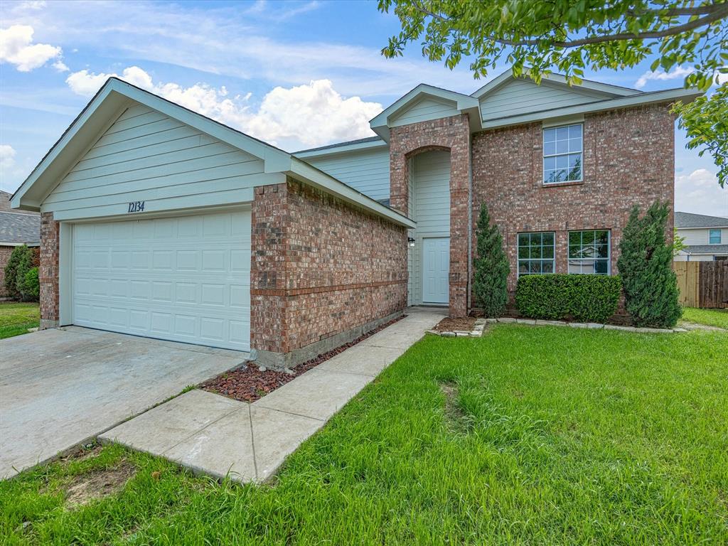 12134 Shine Avenue Rhome, TX 76078 - Photo 1 of 33 a front view of a house with a garden and yard