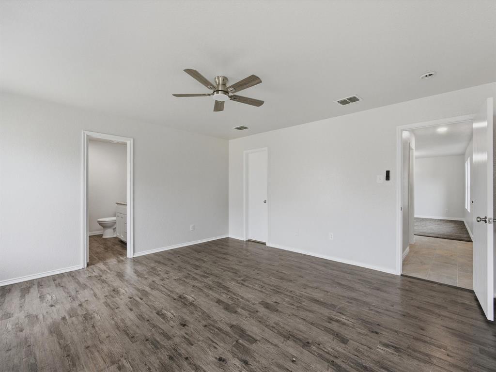 12134 Shine Avenue Rhome, TX 76078 - Photo 16 of 33 a view of empty room with wooden floor and ceiling fan