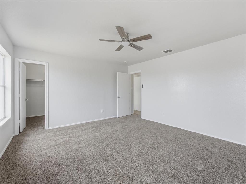 12134 Shine Avenue Rhome, TX 76078 - Photo 19 of 33 an empty room with a ceiling fan and a window