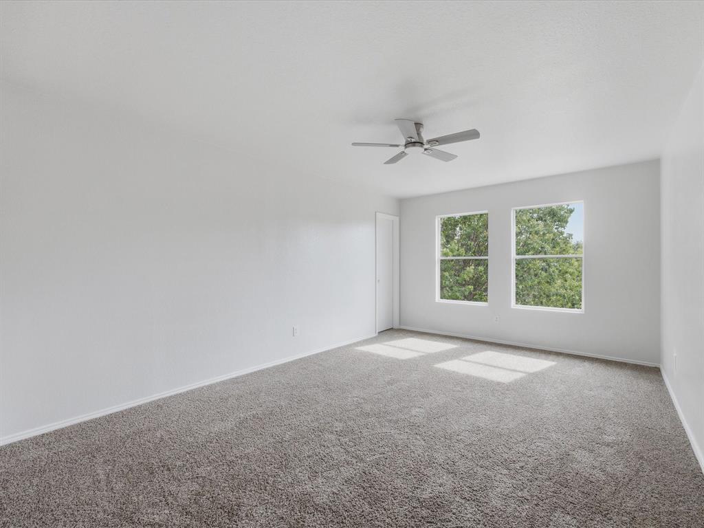 12134 Shine Avenue Rhome, TX 76078 - Photo 24 of 33 a view of a big room with windows and chandelier fan