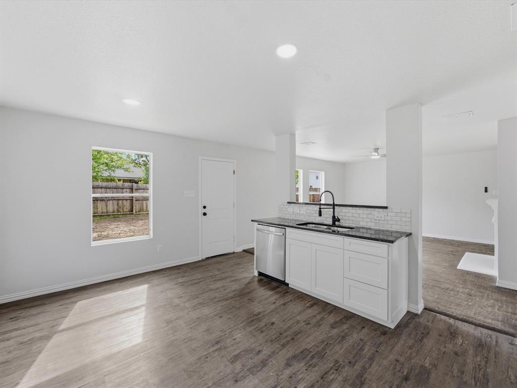 12134 Shine Avenue Rhome, TX 76078 - Photo 6 of 33 a kitchen with stainless steel appliances granite countertop a sink and a stove