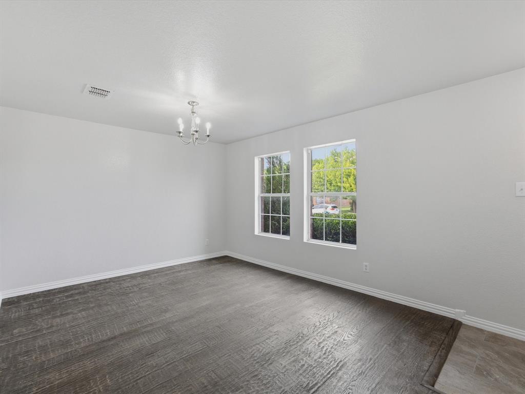 12134 Shine Avenue Rhome, TX 76078 - Photo 8 of 33 wooden floor in an empty room with a window