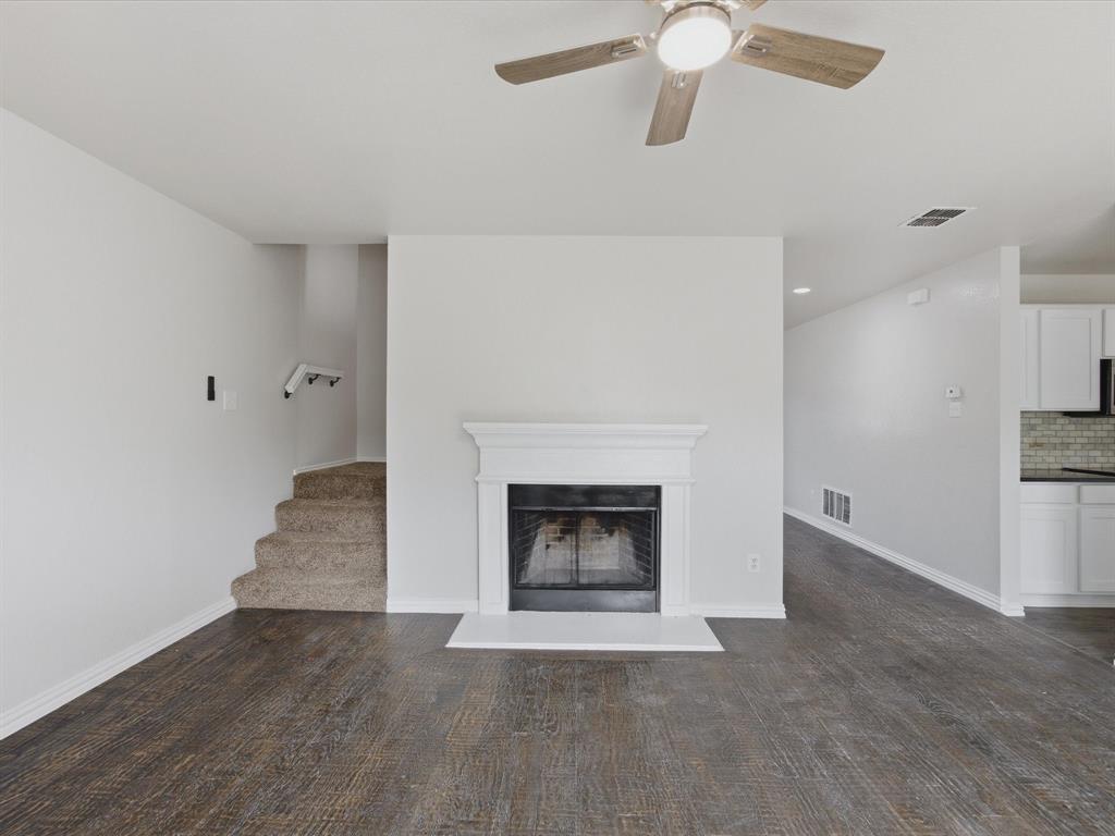 12134 Shine Avenue Rhome, TX 76078 - Photo 9 of 33 a living room with wooden floors and a fireplace