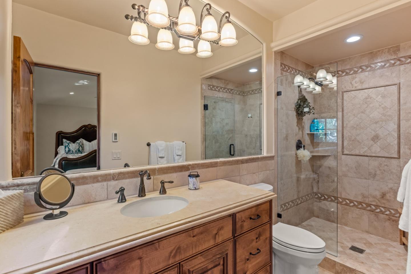 3116 Bird Rock Road Pebble Beach, CA 93953 - Photo 19 of 37 a bathroom with a granite countertop sink a toilet a mirror and shower