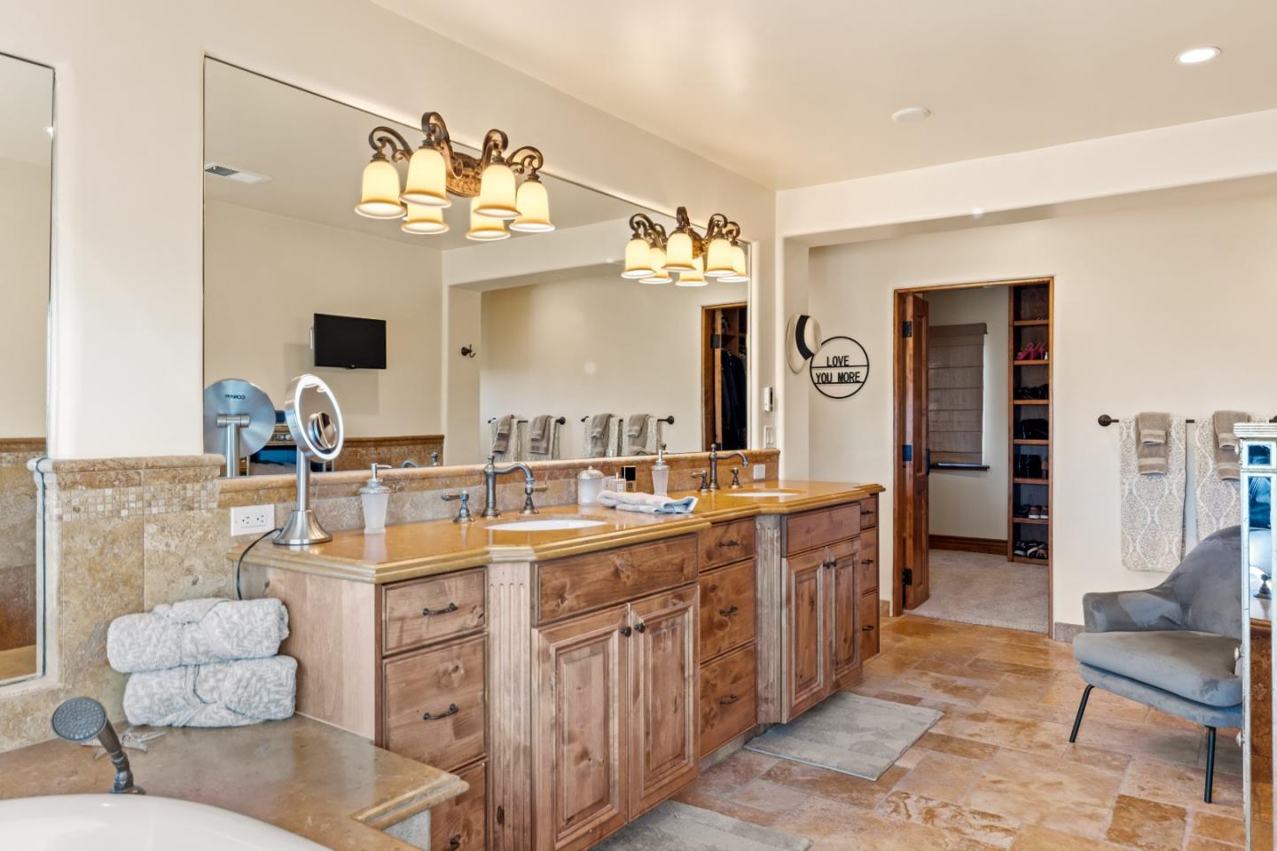 3116 Bird Rock Road Pebble Beach, CA 93953 - Photo 27 of 37 a large bathroom with a double vanity sink a mirror and a bathtub