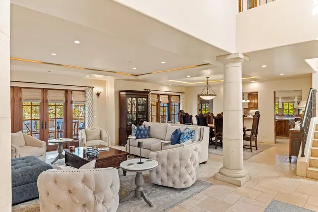 a living room with fireplace furniture and a large window
