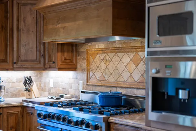 a kitchen with granite countertop a stove and a microwave