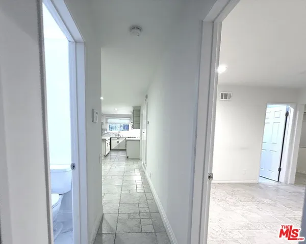 a view of a bathroom with a sink and a mirror