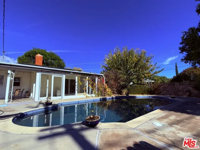 a view of a swimming pool with a yard