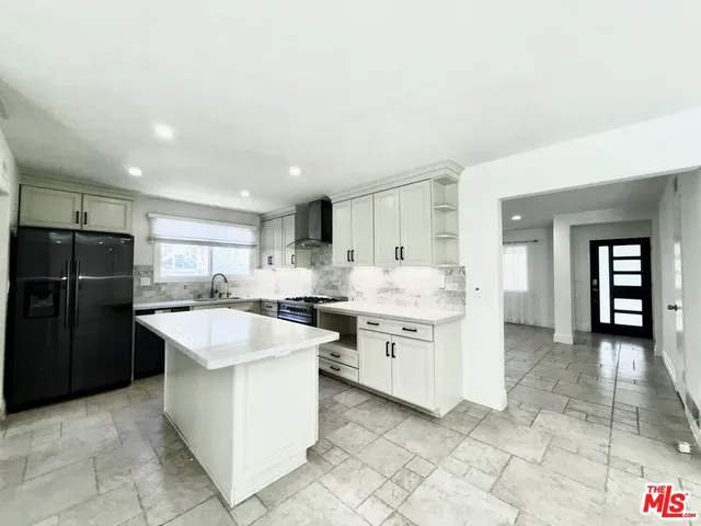 a kitchen with appliances cabinets and furniture