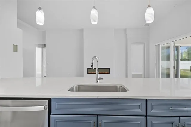 an empty room with a window and a ceiling fan