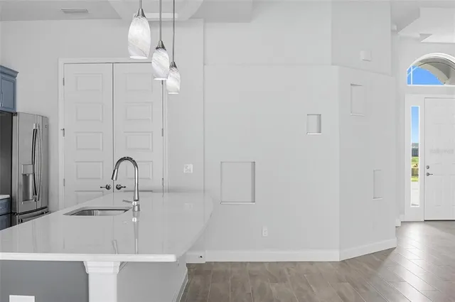 a view of a room with wooden floor and entryway