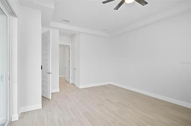 a view of an empty room with wooden floor