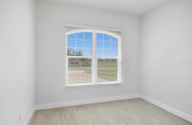 a front view of a house with a yard and potted plants