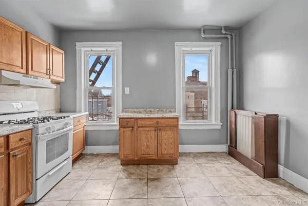 a kitchen with stainless steel appliances granite countertop a stove sink and cabinets