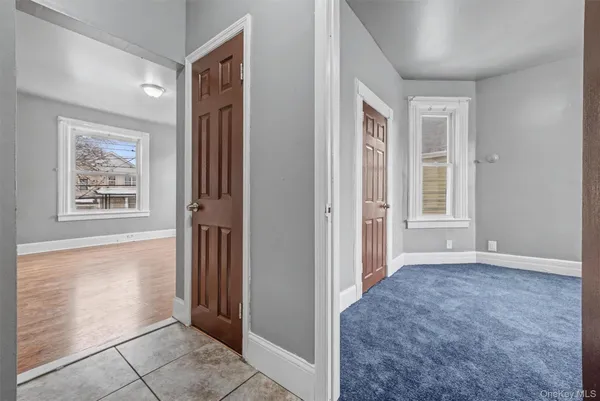 an empty room with windows and closet