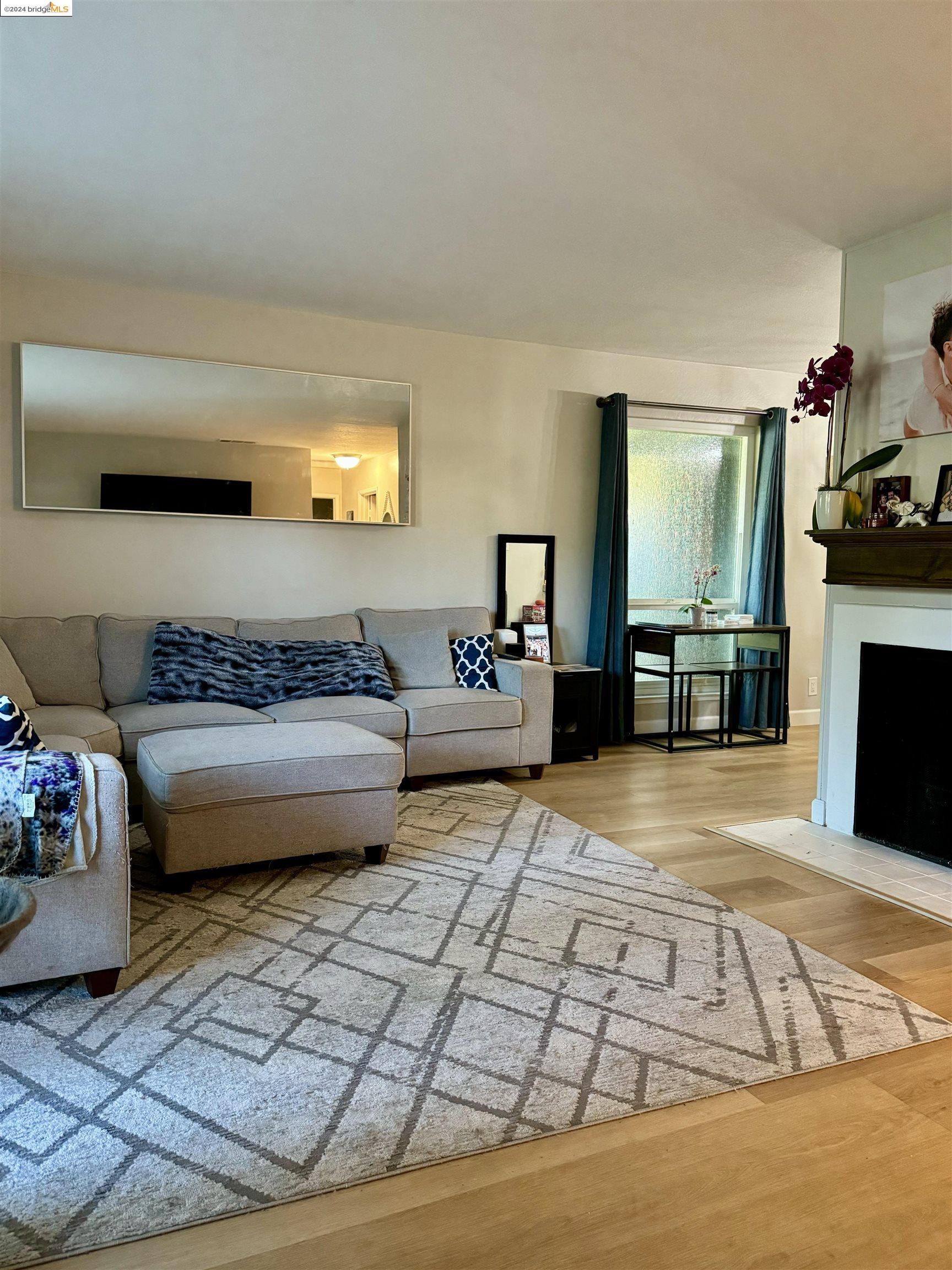 5519 Roundtree Drive, Unit A Concord, CA 94521 - Photo 2 of 9 a bedroom with furniture and a fireplace