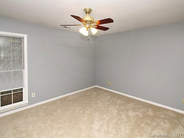 165 McAlway Road Charlotte, NC 28211 - Photo 17 of 23 an empty room with a window and a fan