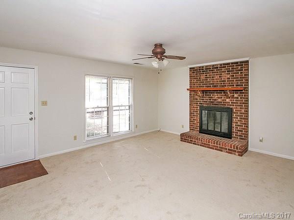 165 McAlway Road Charlotte, NC 28211 - Photo 10 of 23 a view of an empty room with a fireplace and a window