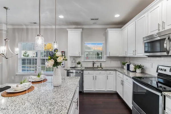 a kitchen with a sink a stove and cabinets