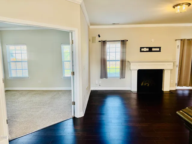 a view of a kitchen with wooden floor and windows