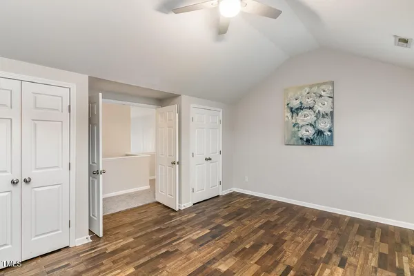 a view of kitchen and empty room with fireplace