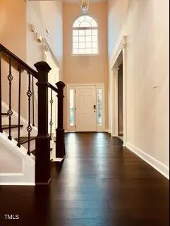 a view of a living room with hardwood floor and a ceiling fan
