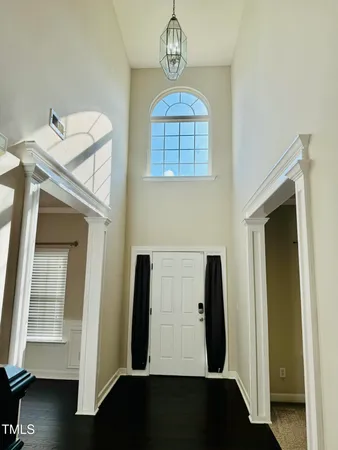 a view of a hallway with entryway wooden floor and front door