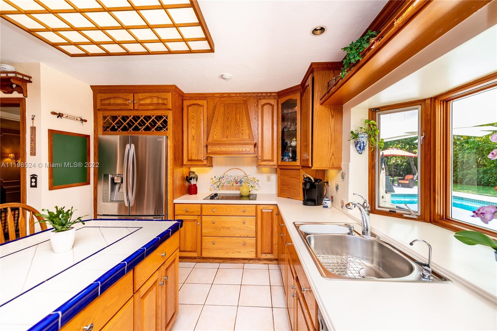 12440 Old Cutler Road Pinecrest, FL 33156 - Photo 21 of 54 a kitchen with a sink and a large window