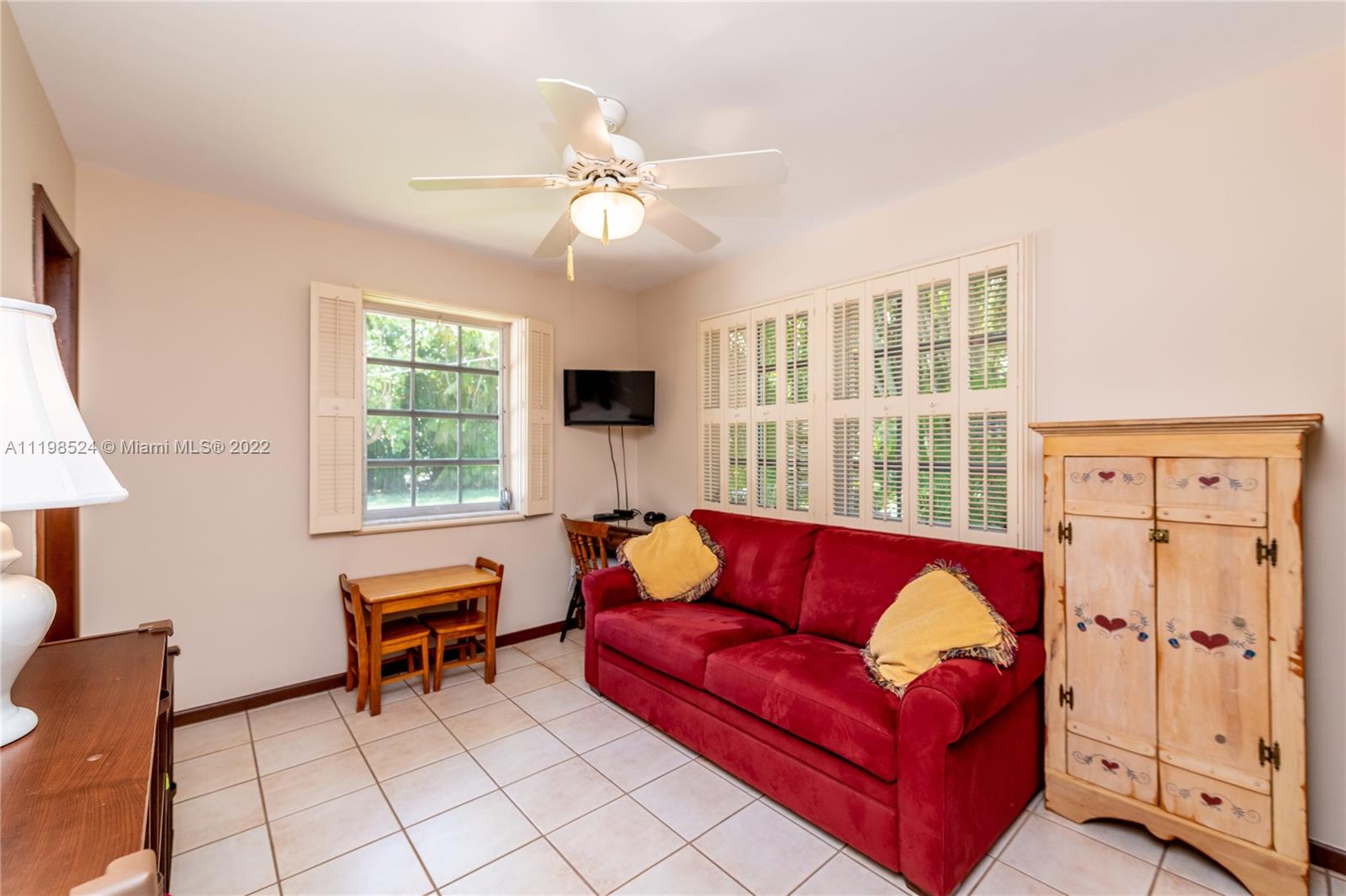 12440 Old Cutler Road Pinecrest, FL 33156 - Photo 36 of 54 a living room with furniture and a window