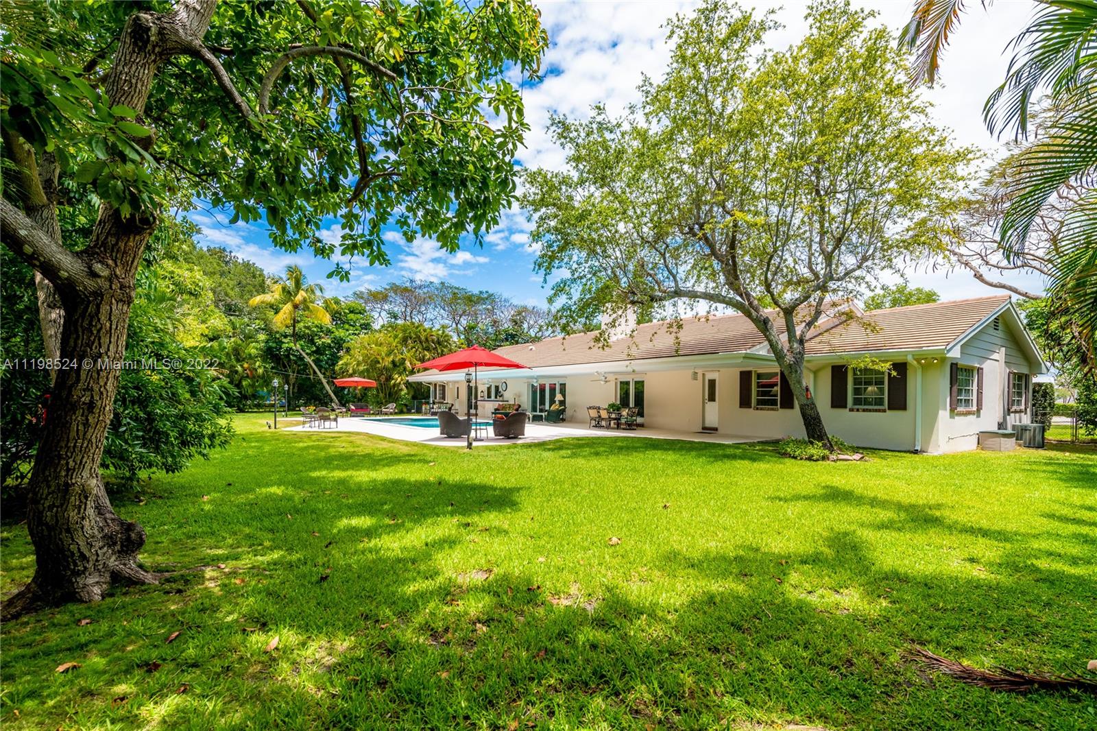 12440 Old Cutler Road Pinecrest, FL 33156 - Photo 49 of 54 a front view of a house with a garden