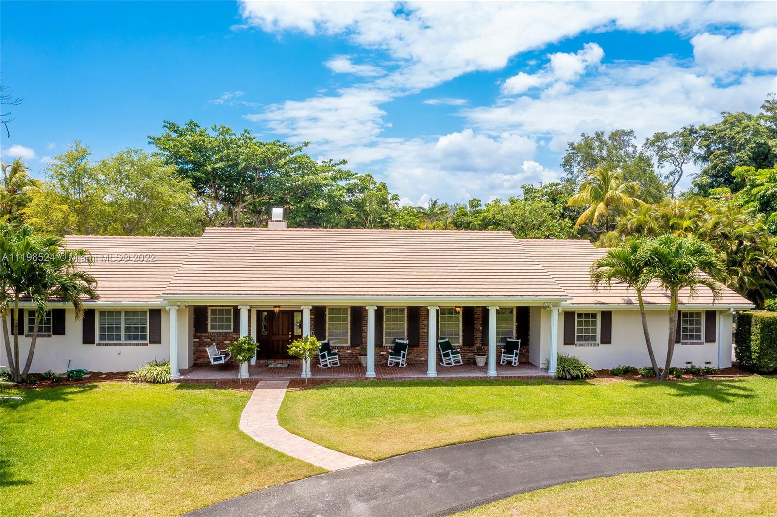 12440 Old Cutler Road Pinecrest, FL 33156 - Photo 7 of 54 a front view of a house with swimming pool having outdoor seating