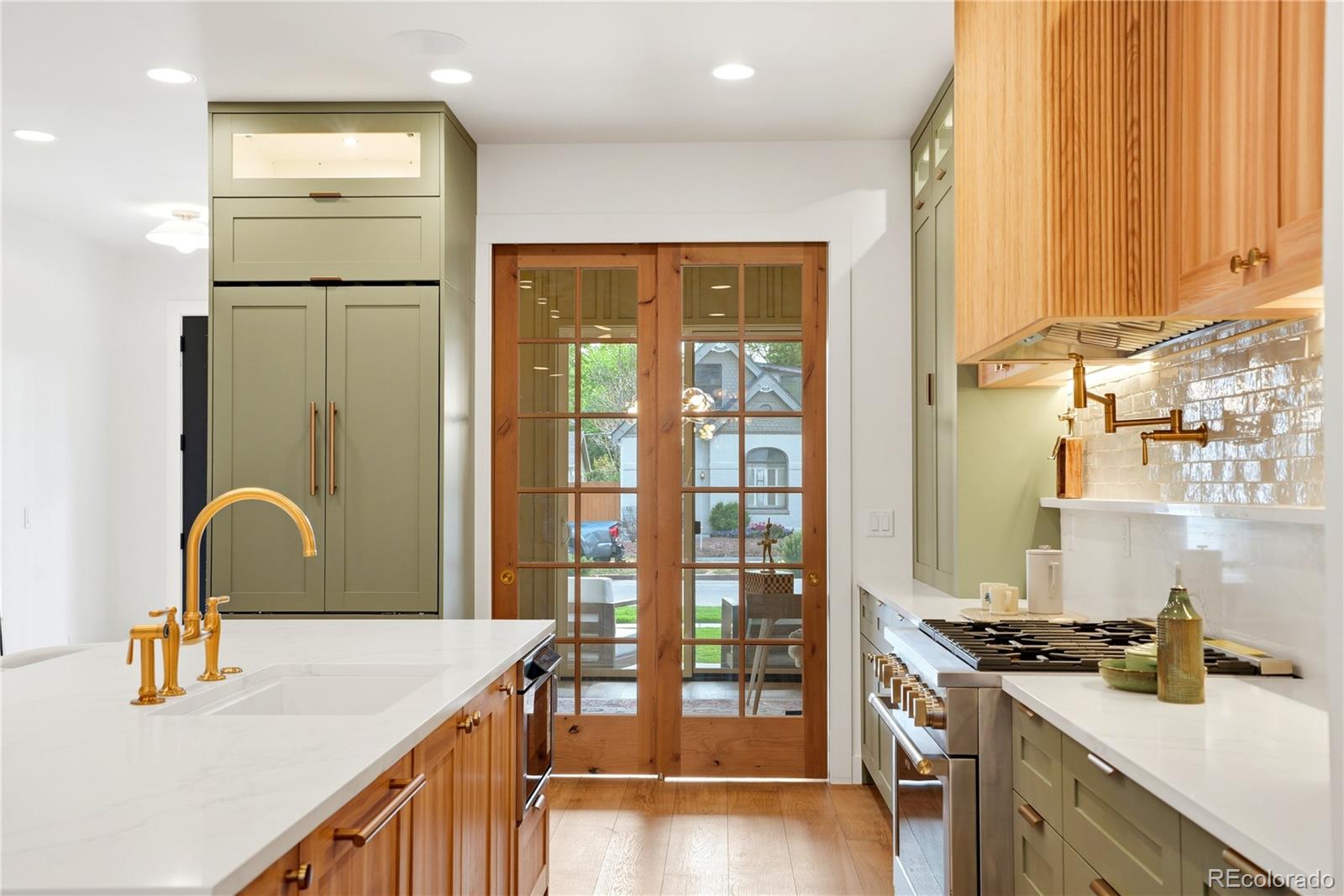 245 South Emerson Street Denver, CO 80209 - Photo 16 of 49 a kitchen with a refrigerator and a stove top oven
