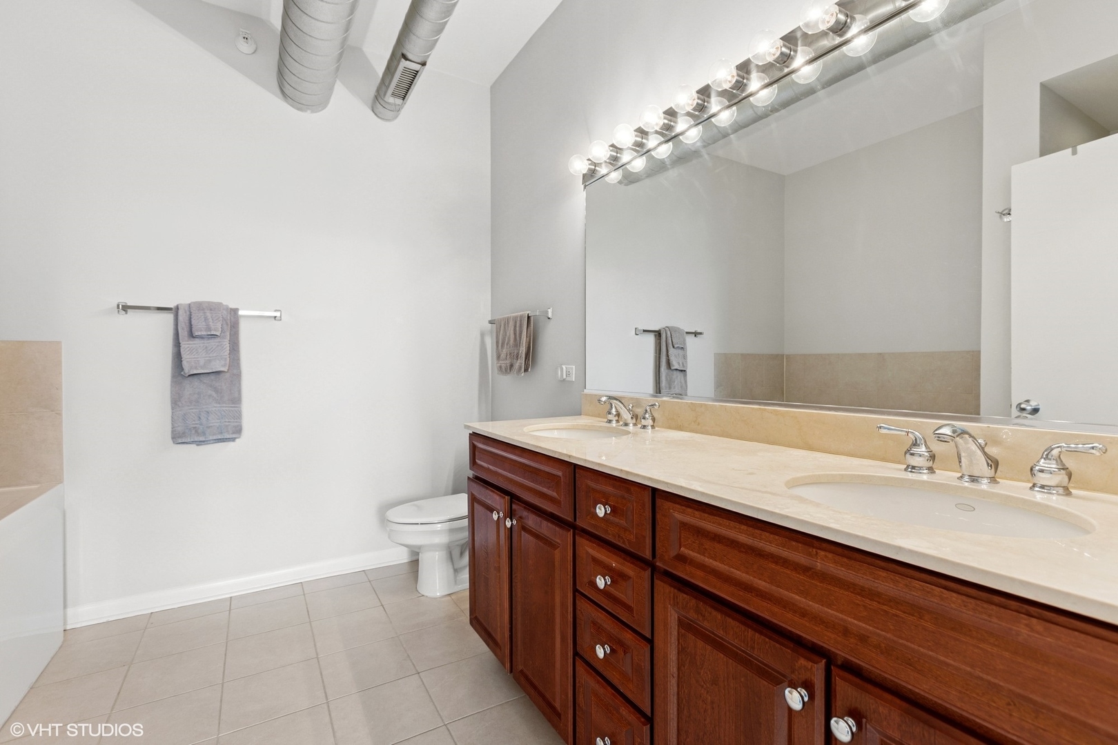 1200 West Monroe Street, Unit 805 Chicago, IL 60607 - Photo 15 of 21 a spacious bathroom with a double vanity sink and a mirror