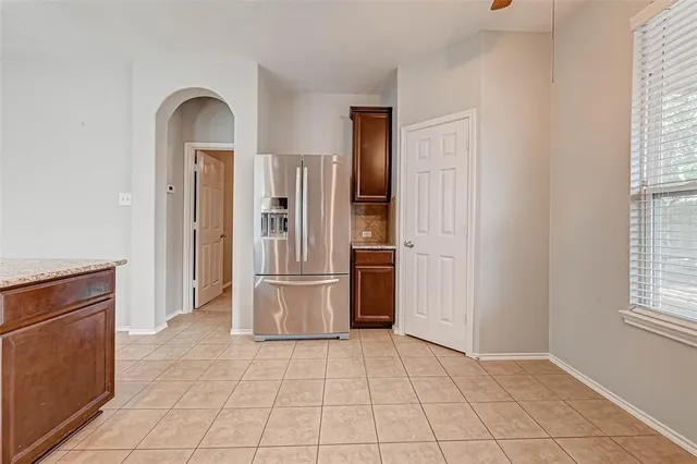 a view of kitchen with refrigerator cabinets and oven