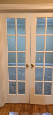 a view of an empty room with wooden floor and cabinet