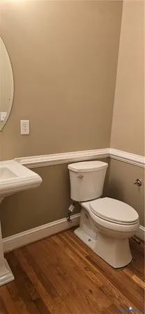 a white toilet sitting next to a white sink