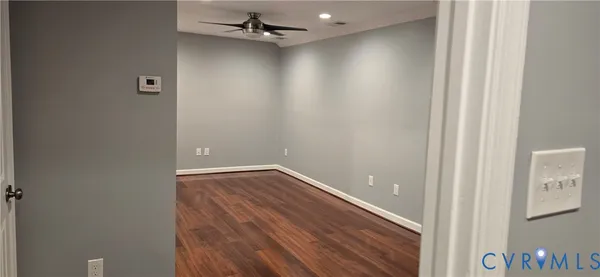a view of a room with wooden floor