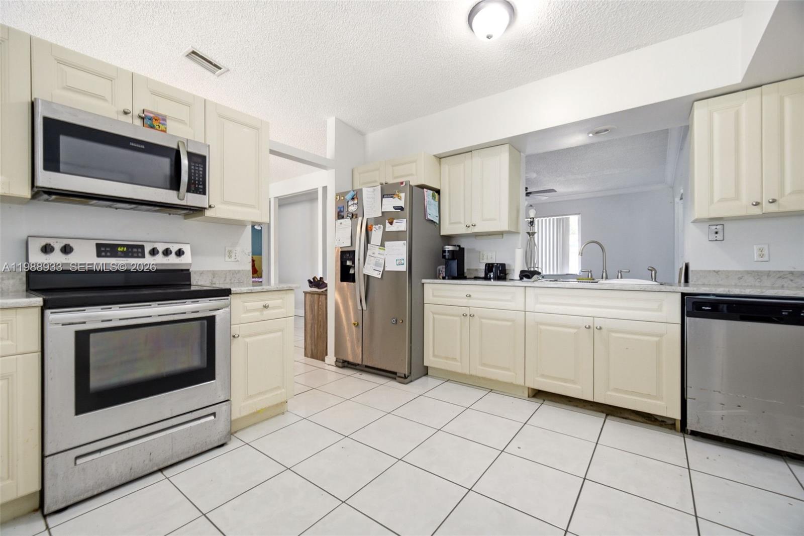 841 Southwest 55th Avenue Margate, FL 33068 - Photo 8 of 26 a kitchen with white cabinets and appliances