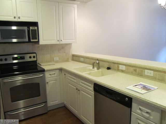 Kitchen. solid surface counter tops, tumbled marble back-splash and SS appliances