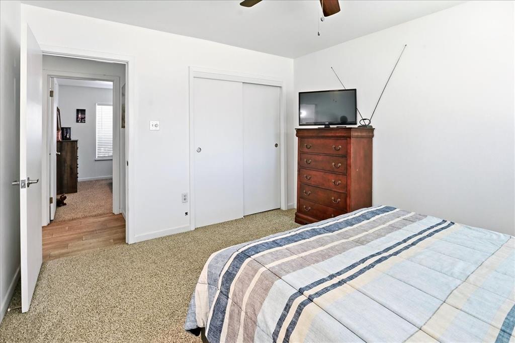 12657 Alma Street Tyler, TX 75704 - Photo 25 of 36 a bedroom with a bed and a flat screen tv