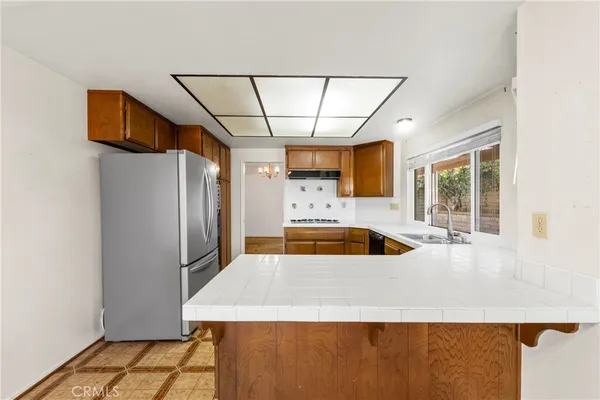 a kitchen with stainless steel appliances a refrigerator sink and cabinets
