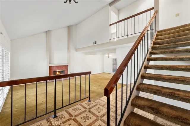 a view of staircase with lots of frames on wall