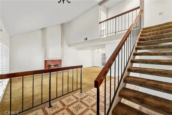 a view of staircase with lots of frames on wall