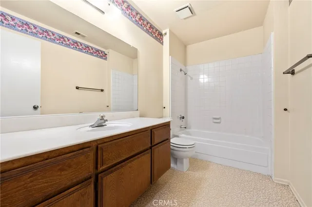 a view of a room with a ceiling fan and a window