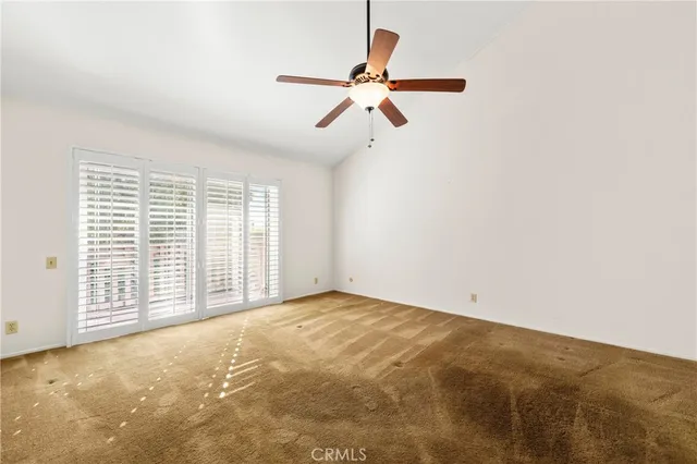a view of a big room with a ceiling fan