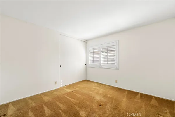 a view of a room with a ceiling fan and a window
