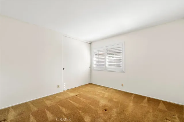 a view of a room with a ceiling fan and a window