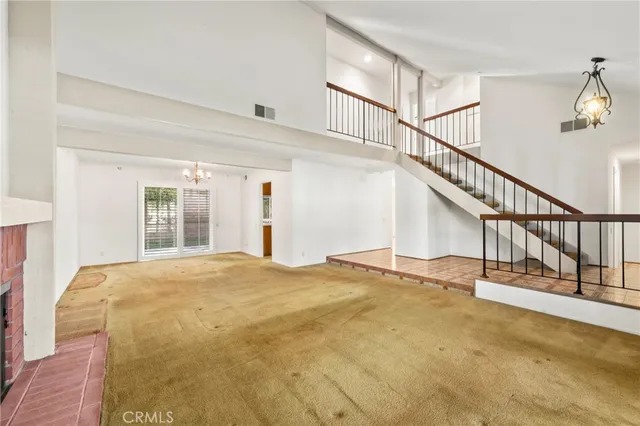 a view of an empty room with stairs